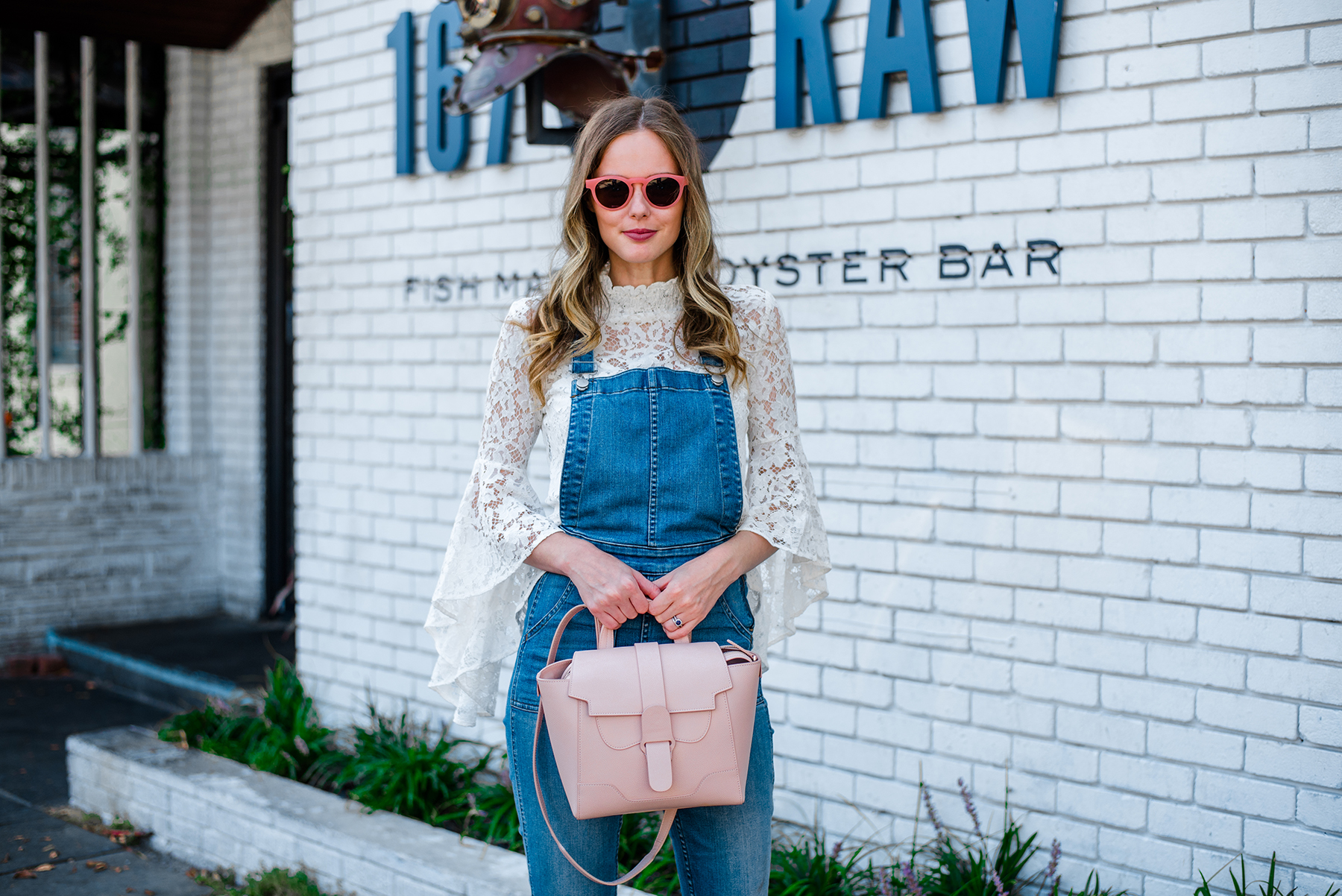 Alyssa Campanella of The A List blog's 48 Hours in Charleston dining at 167 Raw wearing Wayf Citha lace top and Senreve mini Maestra bag