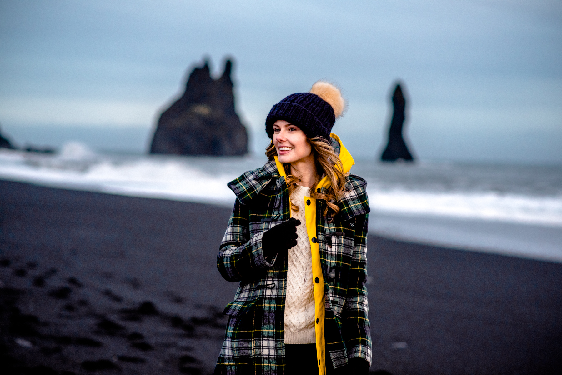 Alyssa Campanella of The A List blog wearing Gloverall plaid coat at Reynisfjara black sand beach on a road trip from Akureyri to Vik, Iceland
