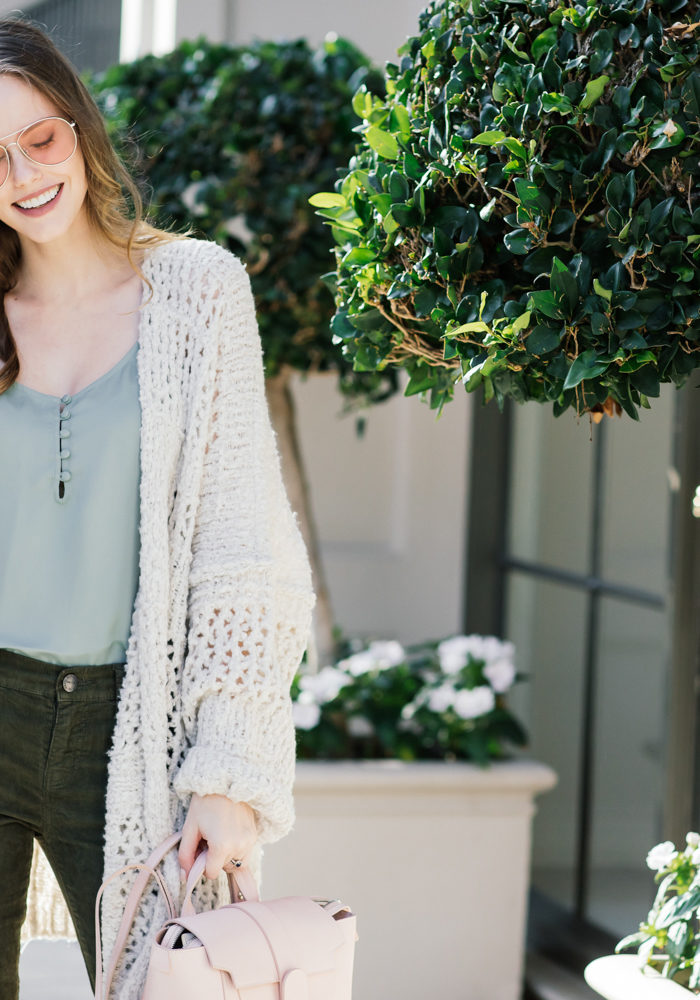Alyssa Campanella of The A List blog wearing Free People Saturday Morning comfy sweater, Senreve mini Maestra bag, and Current Elliott Stiletto jeans