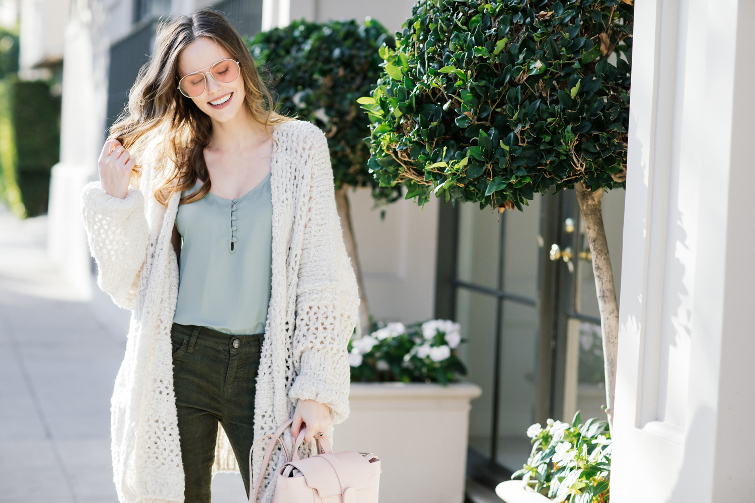 Alyssa Campanella of The A List blog wearing Free People Saturday Morning comfy sweater, Senreve mini Maestra bag, and Current Elliott Stiletto jeans