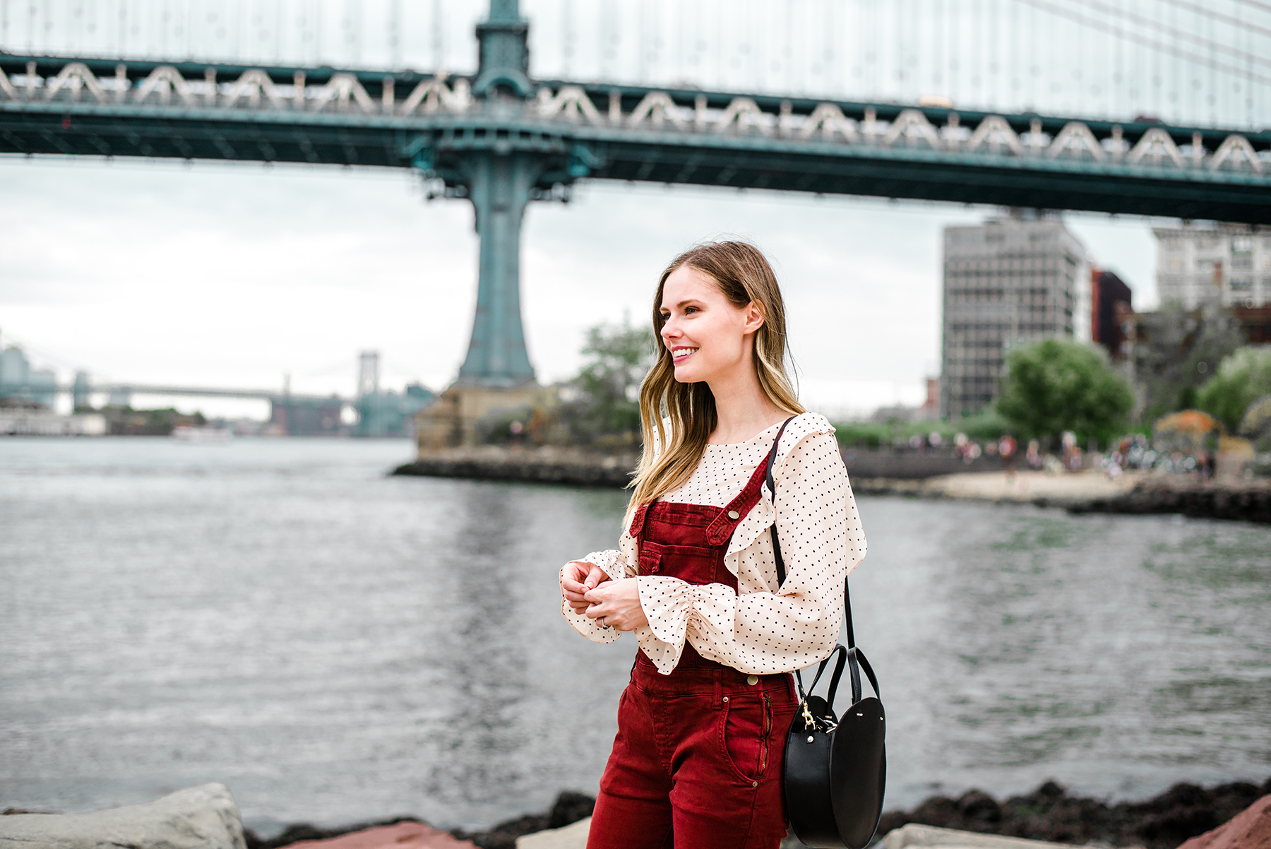 Alyssa Campanella of The A List blog enjoys autumn in New York wearing Free People washed denim overalls and Clare V Alistair bag