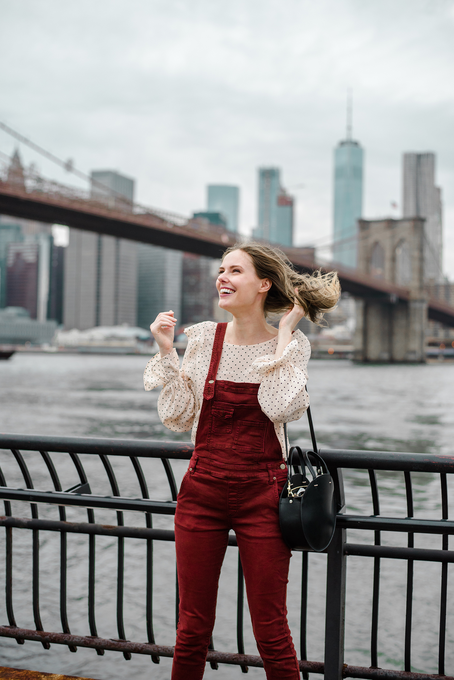 Alyssa Campanella of The A List blog enjoys autumn in New York wearing Free People washed denim overalls and Clare V Alistair bag