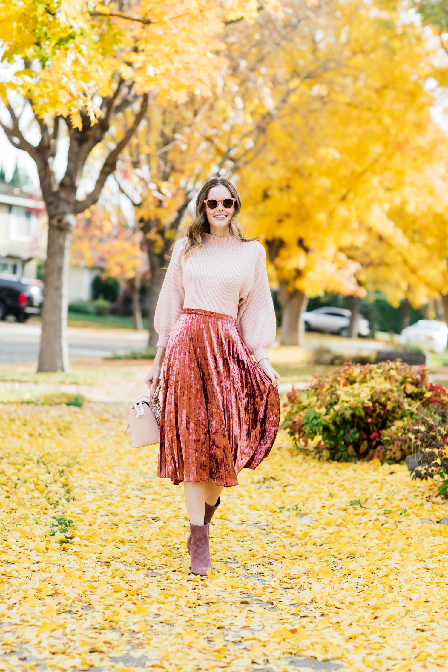Alyssa Campanella of The A List blog wearing holiday pink in Glamorous velvet skirt, Line and Dot Alder sweater, Senreve Mini Maestra bag, and M. Gemi Corsa boots