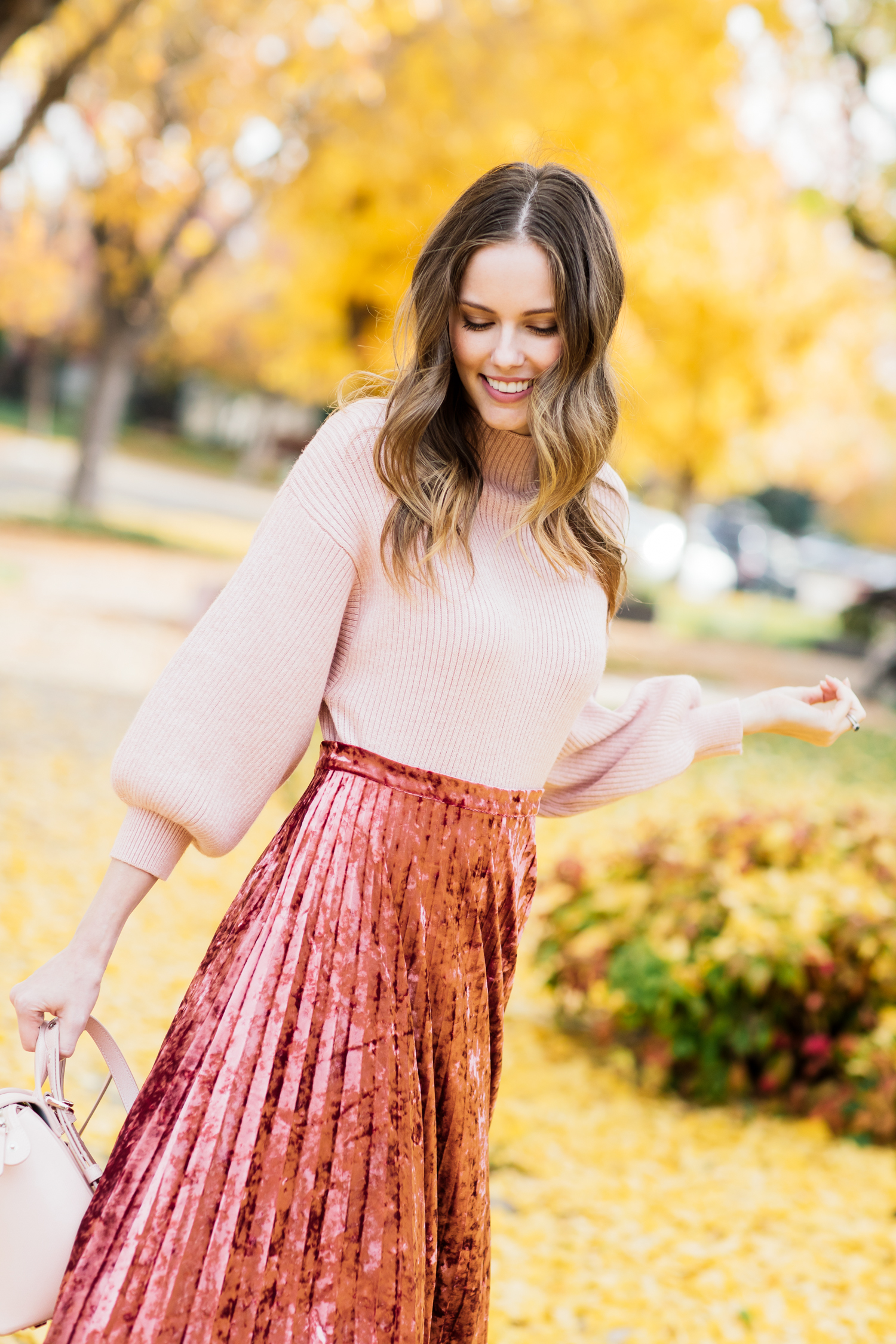 Alyssa Campanella of The A List blog wearing holiday pink in Glamorous velvet skirt, Line and Dot Alder sweater, Senreve Mini Maestra bag, and M. Gemi Corsa boots