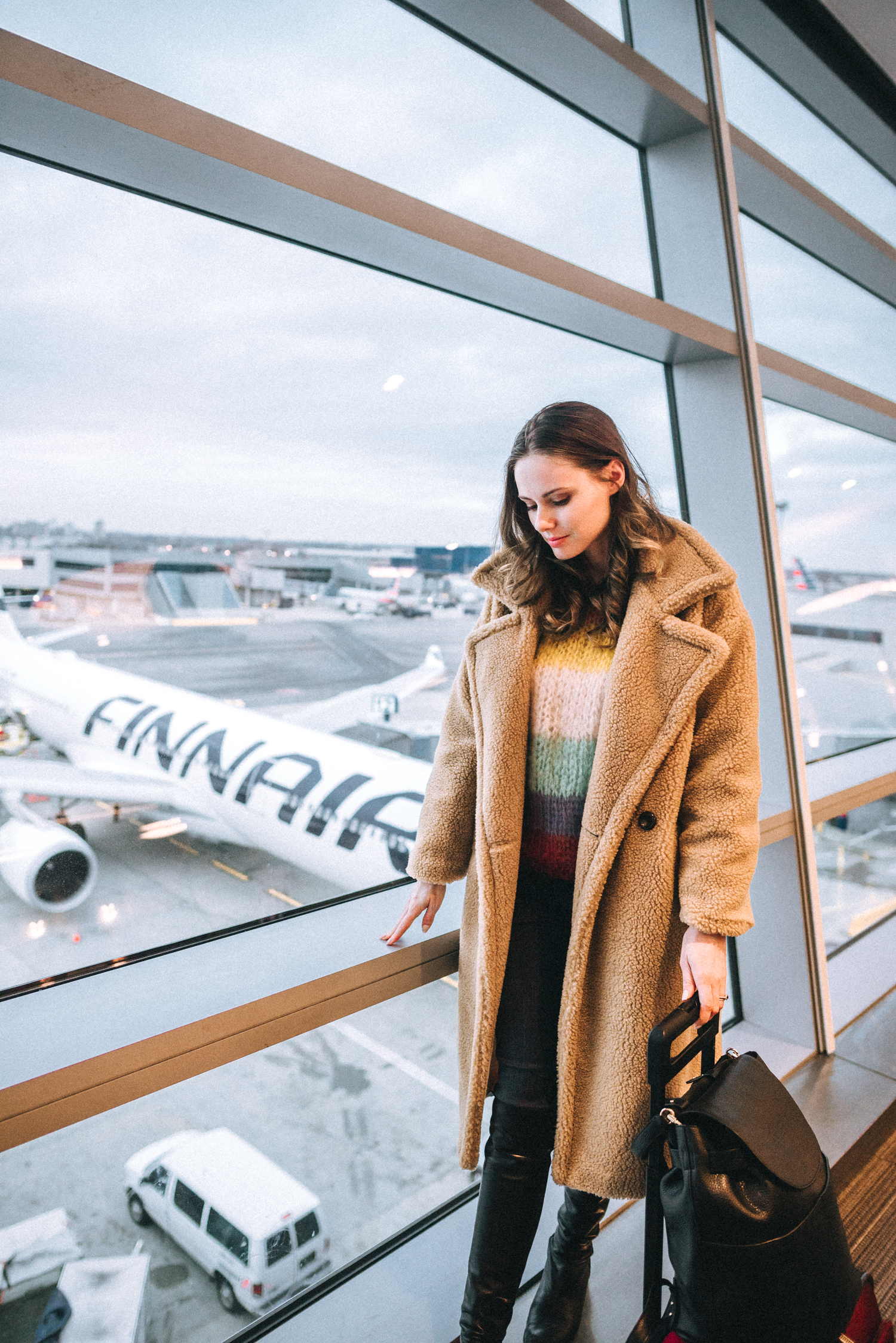 Alyssa Campanella of The A List blog flies to Finland with Finnair wearing Storets Julia teddy coat