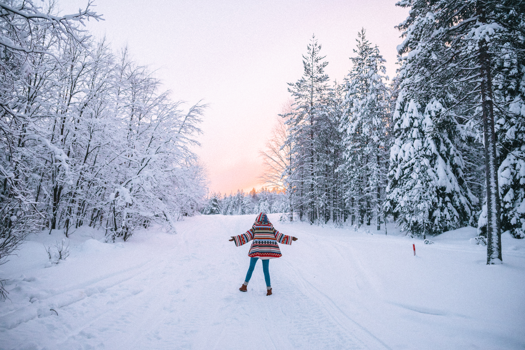 Alyssa Campanella of The A List blog wearing Lindsey Thornburg Tamiami colorful trench cloak in Lapland, Finland