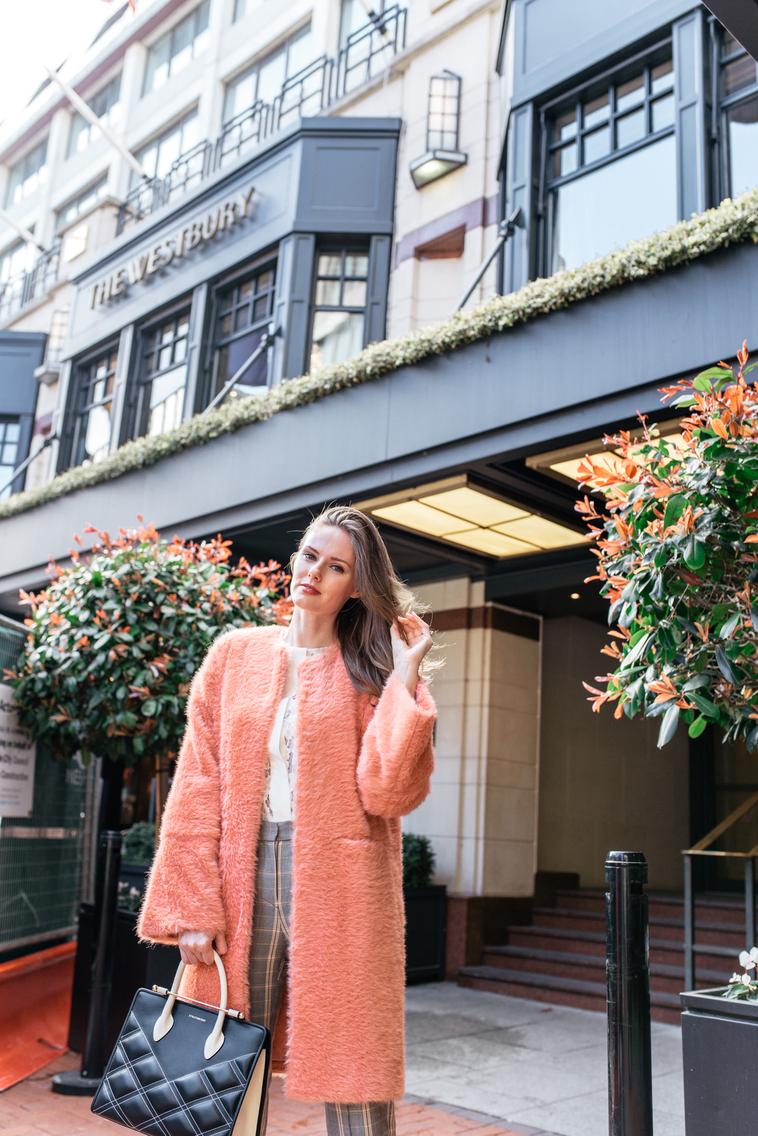 Alyssa Campanella of The A List blog visits The Westbury in Dublin, Ireland wearing By Tsang Fuzzy II robe, Maje Puya plaid pants, and Strathberry quilted midi tote
