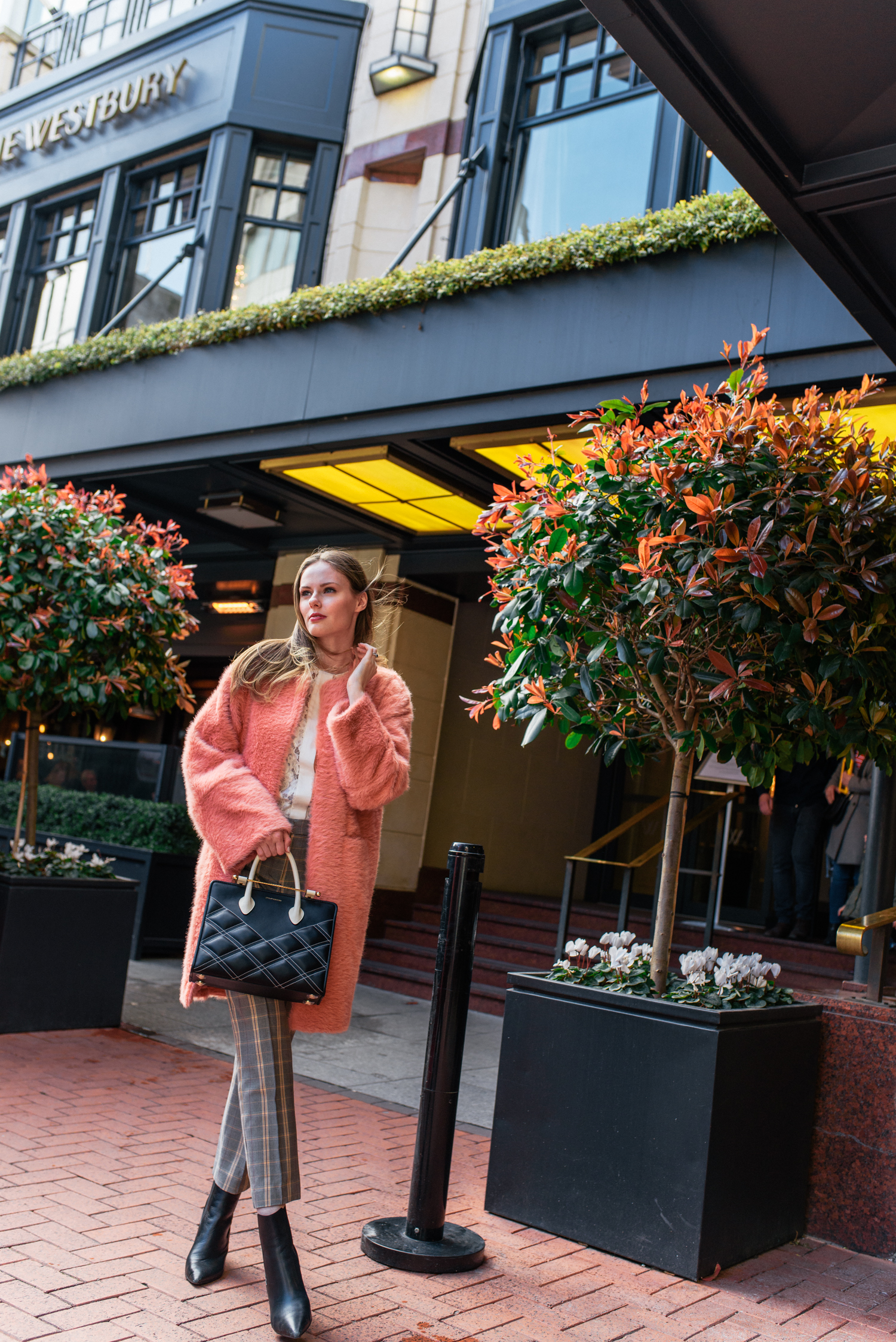 Alyssa Campanella of The A List blog visits The Westbury in Dublin, Ireland wearing By Tsang Fuzzy II robe, Maje Puya plaid pants, and Strathberry quilted midi tote