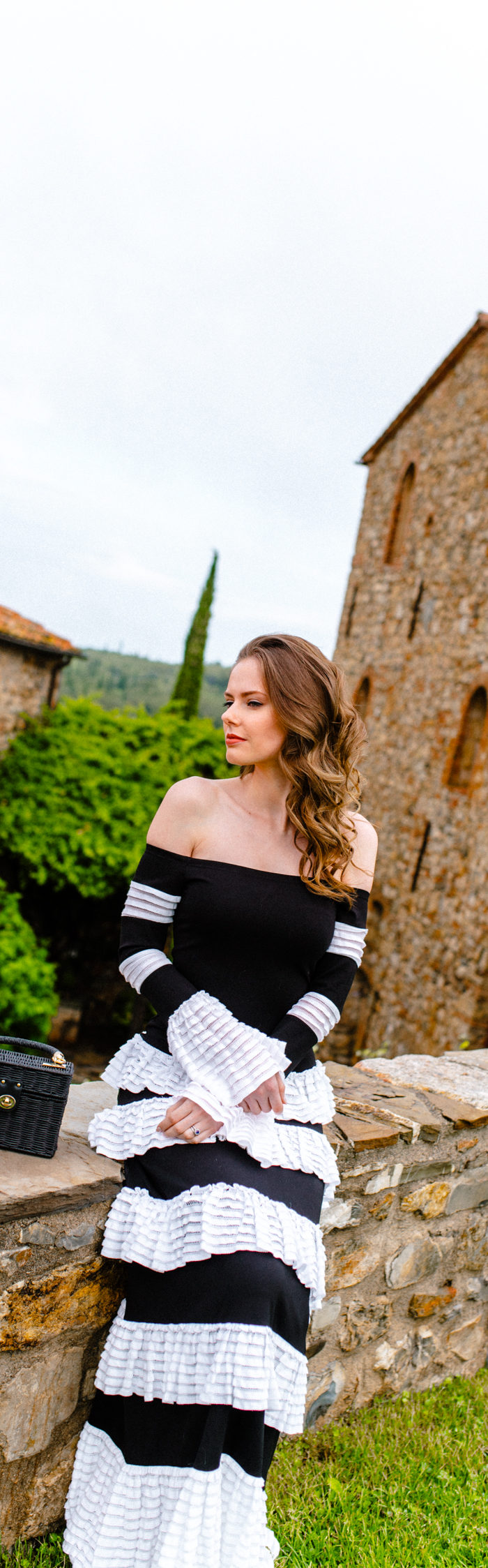 Alyssa Campanella of The A List visits Castello di Vicarello in Tuscany, Italy wearing Alexis off the shoulder ruffle trimmed maxi dress
