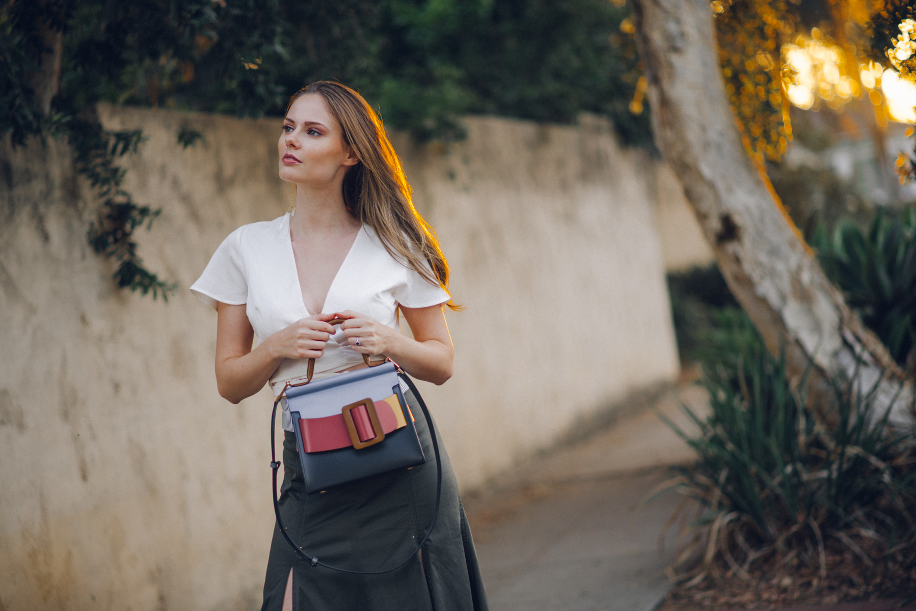 Alyssa Campanella of The A List shares her fall wardrobe staples wearing Silvia Tcherassi abate midi skirt, Boyy boutique Karl bag, and Sezane Pauline boots.